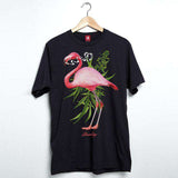 StonerDays Men's Pink Flamingo Tee in black, front view on hanger, vibrant tropical print, 100% cotton