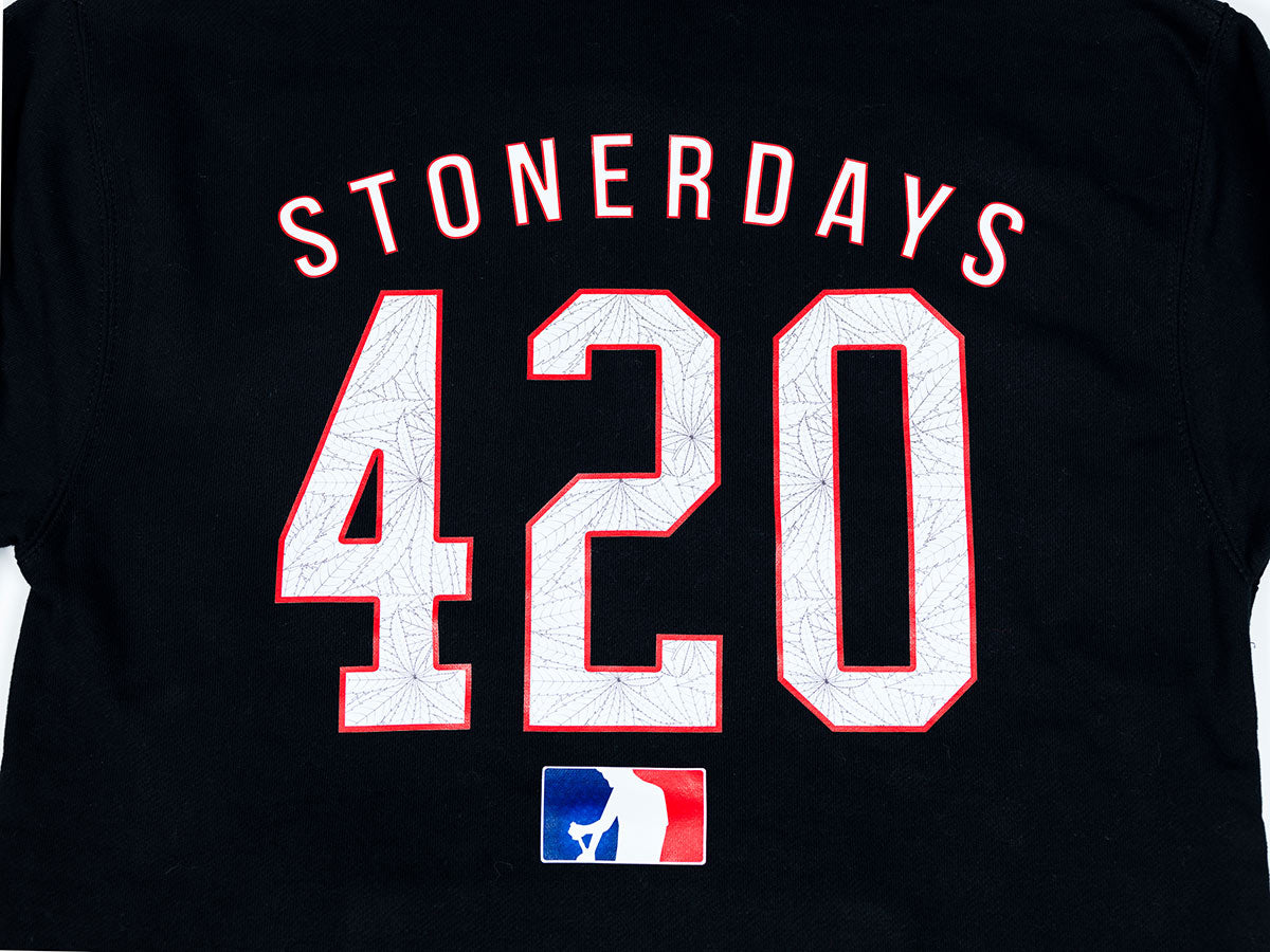 Close-up of StonerDays Mls All Stars Hoodie with bold 420 print on black fabric