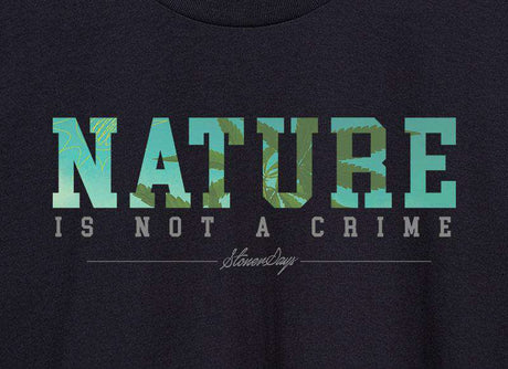 Close-up of StonerDays Women's Racerback with 'Nature Is Not A Crime' print on green organic fabric