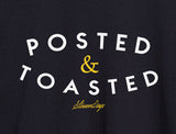 Close-up of StonerDays Posted & Toasted men's black t-shirt with bold white and yellow text