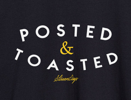 Close-up of StonerDays Posted & Toasted men's black t-shirt with bold white and yellow text