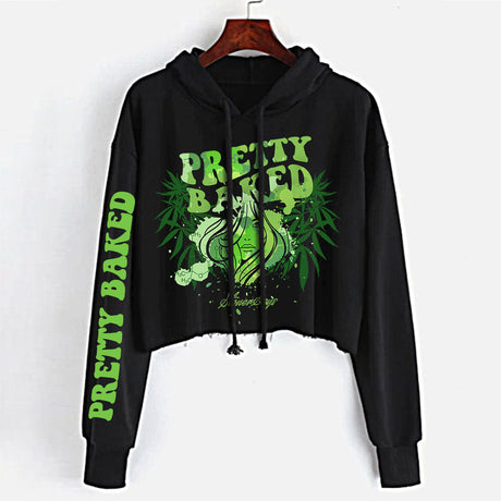 StonerDays Pretty Baked women's crop top hoodie in black with green print, front view on hanger