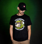 Man wearing StonerDays 'Stay Stoned Save Lives' black cotton t-shirt, front view on green background