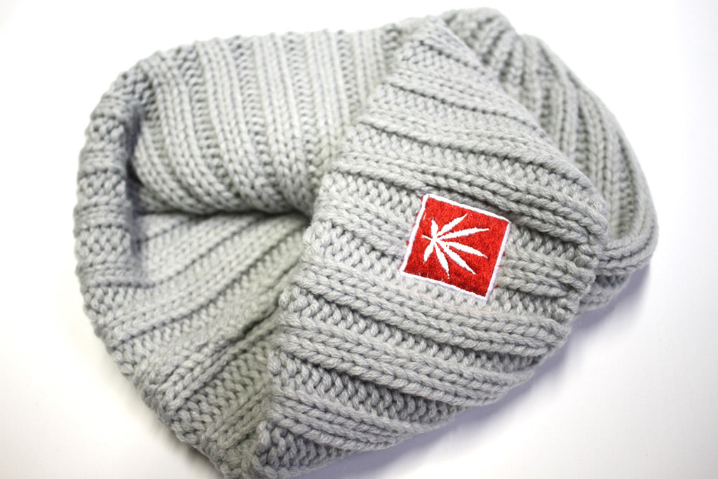StonerDays Grey Knit Beanie with red logo patch, cozy one-size fits all design.