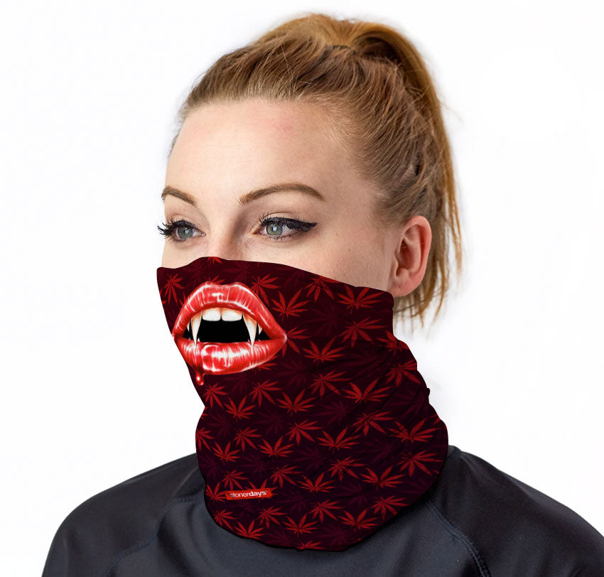 StonerDays Vampire Fangs Neck Gaiter with cannabis leaf pattern, front view on model