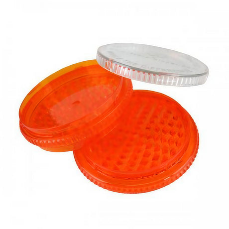 Storz & Bickel Extra Large Dry Herb Grinder in orange and clear acrylic, open view