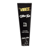 VIBES Ultra Thin Cones 1 1/4" Size 30 Pack, portable rolling papers on a striped background