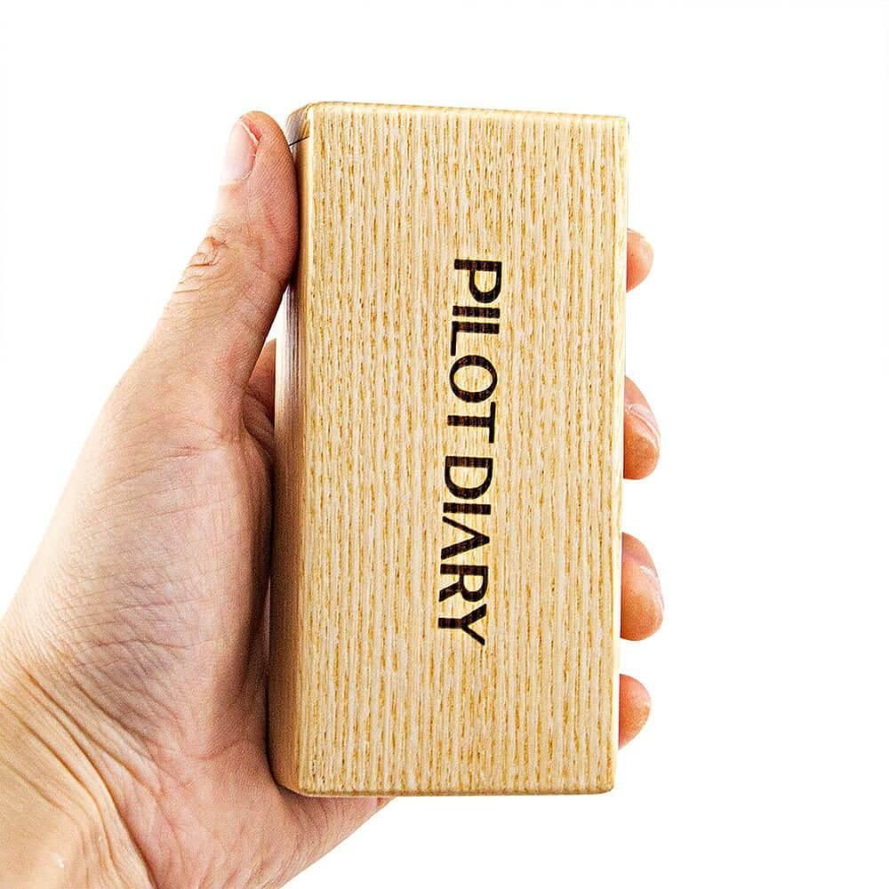PILOT DIARY Wooden Dugout with Cleaning Tool held in hand, front view on white background